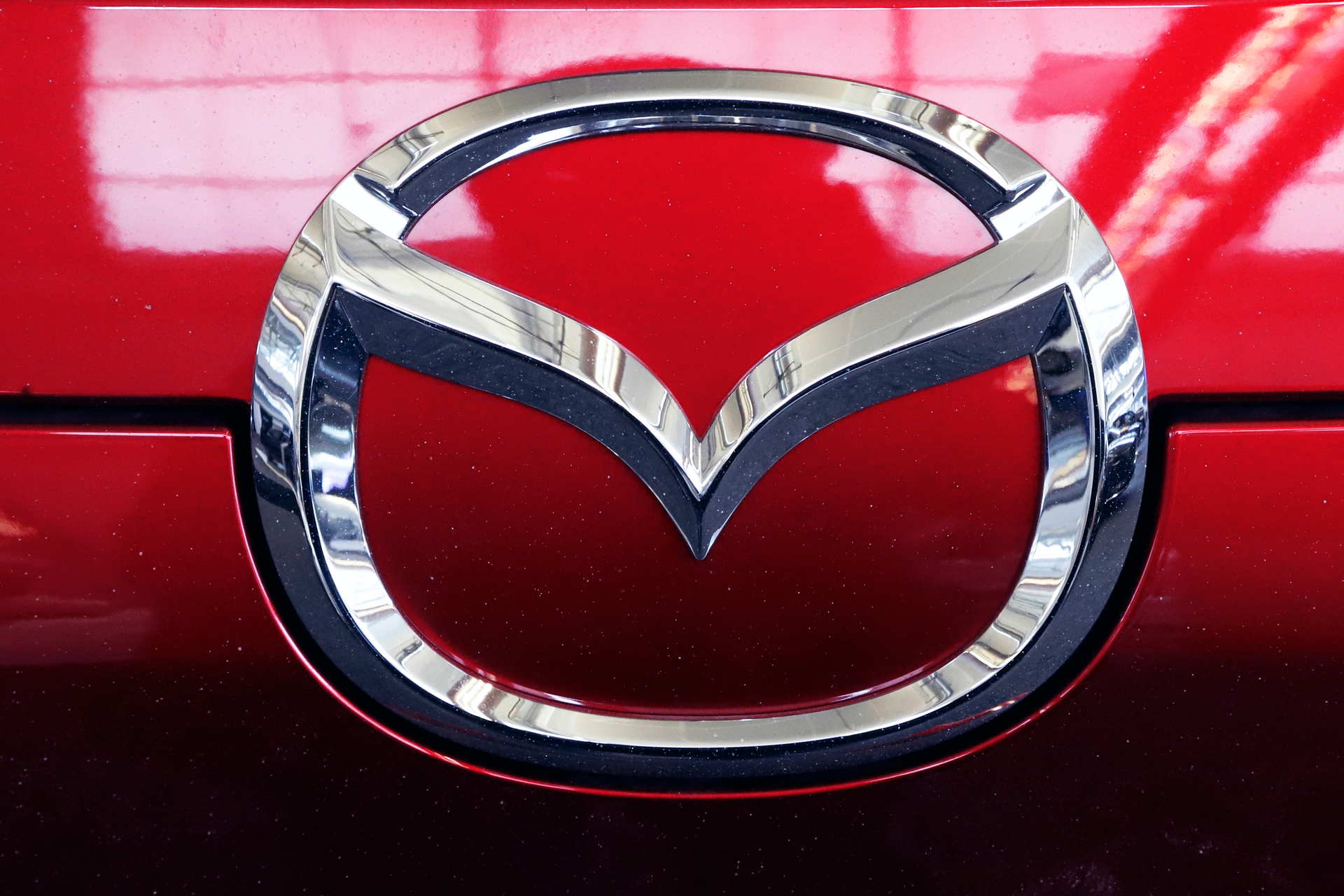 This Feb. 14, 2019, file photo shows the Mazda logo at the 2019 Pittsburgh International Auto Show in Pittsburgh. U.S. safety regulators on Monday, May 6, are investigating reports that side curtain air bags can inflate for no reason on some Mazda CX-9 large SUVs. The probe covers CX-9s from the 2010 through 2013 model years.