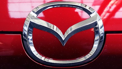This Feb. 14, 2019, file photo shows the Mazda logo at the 2019 Pittsburgh International Auto Show in Pittsburgh. U.S. safety regulators on Monday, May 6, are investigating reports that side curtain air bags can inflate for no reason on some Mazda CX-9 large SUVs. The probe covers CX-9s from the 2010 through 2013 model years.