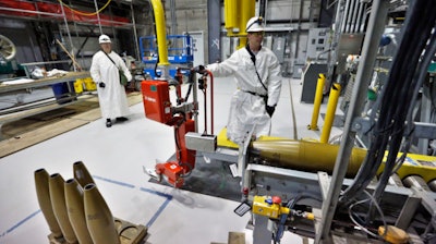 In this Jan. 29, 2015, file photo, ordnance technicians use machines to process inert simulated chemical munitions used for training at the Pueblo Chemical Depot, east of Pueblo, in southern Colorado.