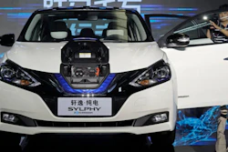In this Aug. 27, 2018, file photo, a cameraman takes video of a Nissan Sylphy Zero Emission, the Nissan's first all-electric vehicle built in China, at the Nissan factory in Guangzhou, Guangdong province, China.