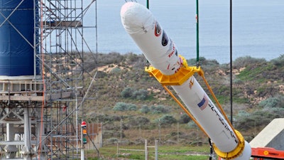 On Space Launch Complex 576-E at Vandenberg Air Force Base in California, Orbital Sciences workers monitor NASA's Glory upper stack as a crane lifts it from a stationary rail for attachment to the Taurus XL rocket's Stage 0.