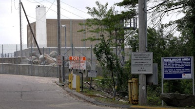 Warning signs are posted near a gate to the Pilgrim Nuclear Power Station, in Plymouth, Mass., Tuesday, May 28, 2019. The operators of the nuclear plant performed a simulated shutdown at a training facility several miles from the reactor Tuesday, in advance of the actual shutdown of the aging reactor planned for Friday, May 31.