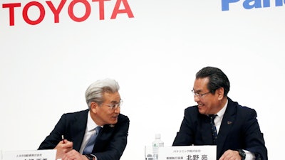 Operating Officer of Toyota Motor Corporation Masayoshi Shirayanagi, left, and Senior Managing Executive Officer of Panasonic Corporation Makoto Kitano talk during a press conference in Tokyo, Thursday, May 9, 2019. Japanese automaker Toyota and electronics maker Panasonic are forming a joint venture combining their housing businesses in Japan.