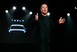 In this March 14, 2019, file photo Tesla CEO Elon Musk speaks before unveiling the Model Y at Tesla's design studio in Hawthorne, Calif. Musk is buying $10M of the electric vehicle maker’s common stock, shortly after saying the company may need to raise money again. Tesla is offering $650M of common stock and $1.35B in convertible senior notes due 2024 in two separate offerings.