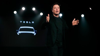 In this March 14, 2019, file photo Tesla CEO Elon Musk speaks before unveiling the Model Y at Tesla's design studio in Hawthorne, Calif. Musk is buying $10M of the electric vehicle maker’s common stock, shortly after saying the company may need to raise money again. Tesla is offering $650M of common stock and $1.35B in convertible senior notes due 2024 in two separate offerings.