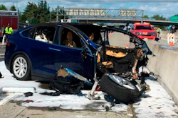 In this March 23, 2018, file photo provided by KTVU, emergency personnel work at the scene where a Tesla electric SUV crashed into a barrier on U.S. Highway 101 in Mountain View, Calif. Federal investigators say the Tesla using the company’s semi-autonomous driving system accelerated just before crashing into a California freeway barrier, killing its driver. The National Transportation Safety Board issued a preliminary report on the crash on Thursday, June 7.