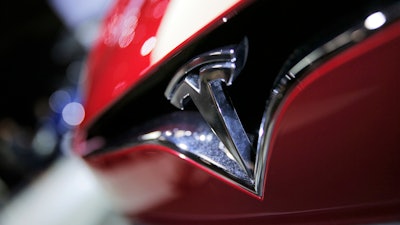 This Sept. 30, 2016, file photo shows the logo of the Tesla model S at the Paris Auto Show in Paris, France. Shares of Tesla are down 50 percent since September 2019, with concerns about Model 3 demand in the U.S. at the forefront. Daniel Ives of WedBush said in a client note Monday, May 20 that so far there seems to be mixed signals on Model 3 demand, which could make it harder for Tesla to achieve a profit in its third and fourth quarters and the future.