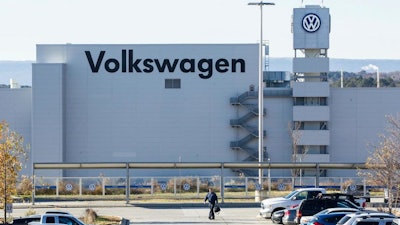 In this Dec. 4, 2015, file photo, a man walks through the employee parking lot at the Volkswagen plant in Chattanooga, Tenn. Tennessee Republican Gov. Bill Lee says he opposes a push by the United Auto Workers union to organize Volkswagen's lone U.S. plant in the state. The Times Free Press quoted Lee as saying Thursday, May 30, 2019, that business recruitment will take a hit if employees at the Chattanooga plant decide they want union representation.