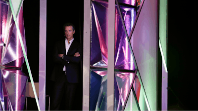 California Gov. Gavin Newsom looks on from the side of the stage before announcing a new X Prize aimed at helping combat wildfires, during the Near Future conference, Friday, May 10, 2019, in San Diego. Newsom announced the new prize Friday alongside X Prize founder and chairman Peter Diamandis, saying the prize will focus on new ways to detect wildfires before they happen and reduce their spread if they occur.