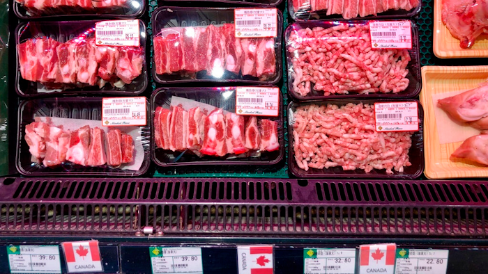 Packs of Canadian pork are displayed for sale at a supermarket in Beijing, Tuesday, June 18, 2019. China will halt imports from a Canadian company after food safety issues were detected in one batch of pork, the Xinhua state news agency reported Tuesday, a move likely to fuel further speculation that China is retaliating against Canada after it arrested a Chinese tech executive.