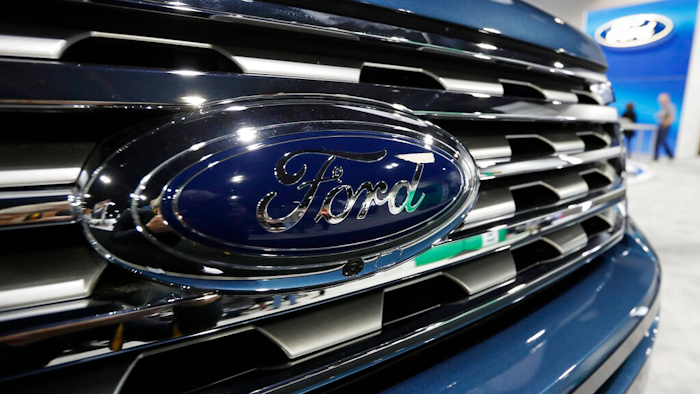 In this file photo dated Thursday, March 28, 2019, the Ford Motor company logo at the auto show in Denver, USA. Carmaker Ford said Thursday June 27, 2019, it is shedding 12,000 jobs in Europe as it streamlines operations in the region to increase profitability.