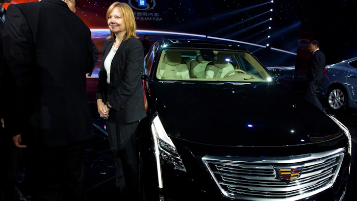 In this April 19, 2015, file photo General Motors CEO Mary Barra stands next to the Cadillac CT6 luxury sedan during a General Motors event ahead of the Auto Shanghai show in Shanghai, China. General Motors is adding 70,000 miles (113,000 kilometers) of roads across the U.S. and Canada to the area where its Cadillac Super Cruise semi-autonomous driving system can run, including some with cross traffic similar to those that have confused Tesla's Autopilot system.