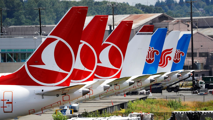 The tails of several of the dozens of grounded Boeing 737 MAX airplanes line the edge of a parking area adjacent to Boeing Field Thursday, June 27, 2019, in Seattle. A new software problem has been found in the troubled Boeing 737 Max that could push the plane's nose down automatically, and fixing the flaw is almost certain to further delay the plane's return to flying after two deadly crashes. Boeing said Wednesday, June 26, 2019, that the FAA 'identified an additional requirement' for software changes that the aircraft manufacturer has been working on for eight months, since shortly after the first crash.