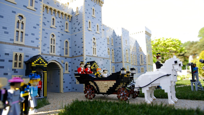 In this Friday, May 11, 2018 file photo, the newest attraction at Legoland in Windsor, England, shows a depiction of the wedding of Prince Harry and Meghan Markle outside Windsor Castle. A group of investors that includes the owners of toy maker Lego is buying Merlin Entertainment, a British company that operates theme parks like Legoland. Merlin said Friday June 28, 2019, it accepted the deal.