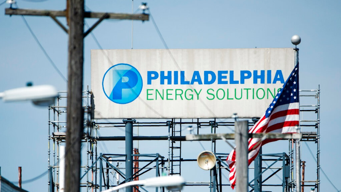 A sign for Philadelphia Energy Solutions stands at the refining complex in Philadelphia, Thursday, June 27, 2019. The largest oil refinery on the East Coast said Wednesday that it will close after a devastating fire last week that set off explosions and damaged equipment.