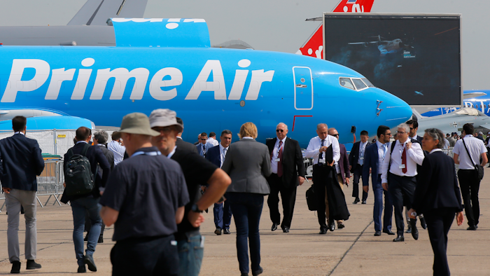 Visitors walk past a Boeing 737-800 BCF Amazon 'Prime Air' cargo plane at the Paris Air Show.