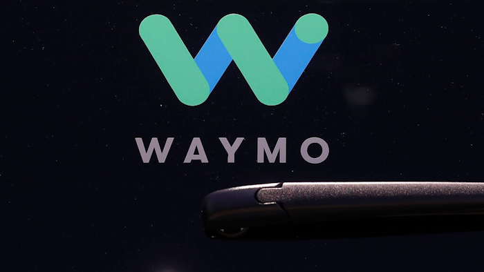 This Tuesday, May 8, 2018, file photo shows a Waymo logo displayed on the window of a car at the Google I/O conference in Mountain View, Calif. Self-driving car pioneer Waymo is teaming up with automakers Renault and Nissan to make its first journey outside the U.S. with a ride-hailing service that will dispatch a fleet of robotaxis in France and Japan.