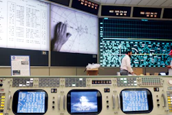 The console for Booster Systems Engineer, the first position on the first row known as 'The Trench,' has an overview of the Display and Projection screens as workers continue restoring the Apollo mission control room to replicate the Apollo mission era 50 years ago at the NASA Johnson Space Center. The screens are displaying, from left, spacecraft telemetry data, the position of astronauts in relation to Lunar Lander while on the moon, and the position of the Command Module as it orbits the moon.