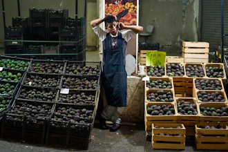 In this file photo, an avocado vendor talks on his cellphone at a market in Mexico City.