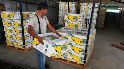 In this May 31, 2019 file photo, =a worker stacks a box of freshly harvested Chiquita bananas to be exported, at a farm in Ciudad Hidalgo, Chiapas state, Mexico. President Donald Trump plans to impose 5% tariffs on Mexican imports starting June 10 and to ratchet them up to 25% by Oct. 1 if the Mexicans don’t do more to stop the surge of Central American migrants across the southern U.S. border.
