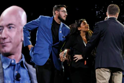 Security removes a protestor from the stage as Amazon CEO Jeff Bezos speaks at the the Amazon re:MARS convention in Las Vegas.