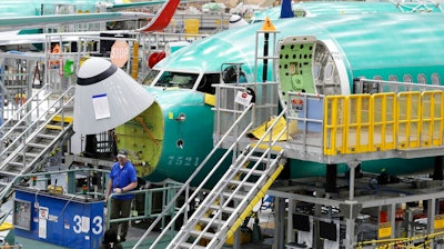 In this March 27, 2019, file photo, a Boeing 737 MAX 8 airplane is shown on the assembly line during a brief media tour of Boeing's 737 assembly facility in Renton, Wash. With the 737 Max jet still grounded after two deadly crashes, deliveries of new Boeing jets are falling far behind last year's pace. Boeing said Tuesday, June 11, 2019, that it delivered 30 commercial airliners during May, down 56% from the 68 it made in May 2018.