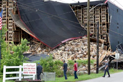 Workers from O.Z. Tyler Distillery look over Warehouse H, which collapsed during a thunderstorm shortly after midnight Monday, June 17, 2019 in Owensboro, Ky. Master Distiller Jacob Call says around 20,000 barrels are stored at the location and it appears that about 4,000 were affected.