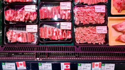 Packs of Canadian pork are displayed for sale at a supermarket in Beijing, Tuesday, June 18, 2019. China will halt imports from a Canadian company after food safety issues were detected in one batch of pork, the Xinhua state news agency reported Tuesday, a move likely to fuel further speculation that China is retaliating against Canada after it arrested a Chinese tech executive.