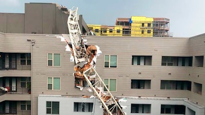 This photo provided by Michael Santana shows the scene after a crane collapsed into Elan City Lights apartments in Dallas amid severe thunderstorms Sunday, June 9, 2019.