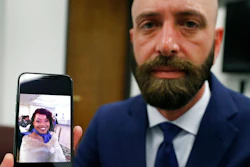 In this Wednesday, June 19, 2019 photo, Eric Ridenhour poses with a photo he took of his fiancee Kiersten Smith. Smith was killed in the June 9 crane collapse in downtown Dallas.
