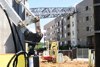 This photo provided by Scott Flodin shows a crane that fell on an apartment building amid severe thunderstorms, Sunday, June 9, 2019, in Dallas. The crane fell after the National Weather Service issued a severe thunderstorm watch for the greater Dallas/Fort Worth area.