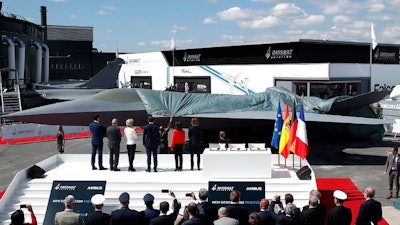 French President Emmanuel Macron, Eric Trappier, Chairman and CEO of Dassault Aviation, Dirk Hoke, CEO of Airbus Defense and Space, Spanish Defense Minister Margarita Robles, German Defense Minister Ursula von der Leyen and French Defense Minister Florence Parly attend the unveiling of the French-German-Spanish New Generation Fighter (NGF) model during a visit at Le Bourget Airport near Paris, France, Monday June 17, 2019. The world's aviation elite are gathering at the Paris Air Show with safety concerns on many minds after two crashes of the popular Boeing 737 Max.