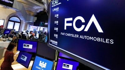 In this May 28, 2019, file photo, the Fiat Chrysler Automobiles logo appears above a post on the floor of the New York Stock Exchange. Japanese automaker Nissan wasn’t consulted about a proposed merger between its French alliance partner Renault and Fiat Chrysler and has little say over the issue. Partnering with a colossal Renault-Fiat Chrysler could help Nissan slash costs on shared components and research.