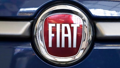 In this Feb. 14, 2019, file photo, the Fiat logo is mounted on a 2019 500 L on display at the 2019 Pittsburgh International Auto Show in Pittsburgh. Fiat Chrysler is in talks to produce self-driving commercial vehicles with Aurora, an autonomous vehicle company led by former Google, Tesla and Uber executives. FCA and Aurora have a deal to lay the groundwork for a partnership to use Aurora's self-driving system globally in Ram and Fiat vehicles used for deliveries and other duties.