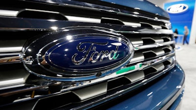 In this file photo dated Thursday, March 28, 2019, the Ford Motor company logo at the auto show in Denver, USA. Carmaker Ford said Thursday June 27, 2019, it is shedding 12,000 jobs in Europe as it streamlines operations in the region to increase profitability.