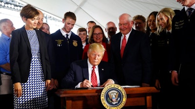 President Donald Trump signs an executive order to streamline the approval process for GMO crops, after speaking at Southwest Iowa Renewable Energy in Council Bluffs, Iowa, Tuesday, June 11, 2019.