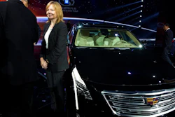 In this April 19, 2015, file photo General Motors CEO Mary Barra stands next to the Cadillac CT6 luxury sedan during a General Motors event ahead of the Auto Shanghai show in Shanghai, China. General Motors is adding 70,000 miles (113,000 kilometers) of roads across the U.S. and Canada to the area where its Cadillac Super Cruise semi-autonomous driving system can run, including some with cross traffic similar to those that have confused Tesla's Autopilot system.