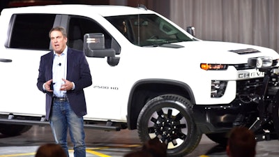 In this Feb. 5, 2019, file photo General Motors President Mark Reuss unveils the Chevrolet Silverado HD at Flint Assembly in Flint, Mich. General Motors says it will spend $150 million so it can make more heavy-duty pickup trucks at its Flint, Michigan, assembly plant. The money will improve the factory’s conveyor system and for other equipment to boost output.