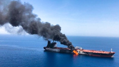 In this Thursday, June 13, 2019 file photo, an oil tanker is on fire in the sea of Oman. A series of attacks on oil tankers near the Persian Gulf has ratcheted up tensions between the U.S. and Iran -- and raised fears over the safety of one of Asia’s most vital energy trade routes, where about a fifth of the world’s oil passes through its narrowest at the Strait of Hormuz. The attacks have jolted the shipping industry, with many of operators in the region on high alert.