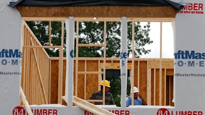 In this June 13, 2019, photo work continues on a new home in Mechanicsville, Va. On Tuesday, June 18, the Commerce Department reports on U.S. home construction in May.