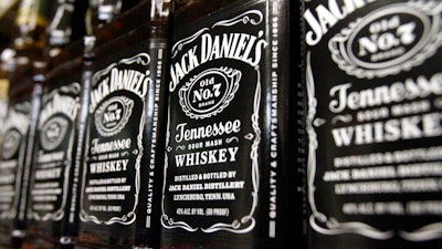 In this Dec. 5, 2011, file photo, bottles of Jack Daniel's Tennessee Whiskey line the shelves of a liquor outlet in Montpelier, Vt. The company that makes Jack Daniels took a hit from the Trump administration’s tariff fight, estimating that the standoff dragged sales growth down by a percentage point for the entire year. Brown-Forman Corp. (BF.A) on Wednesday, June 5, 2019, reported fiscal fourth-quarter net income of $159 million.