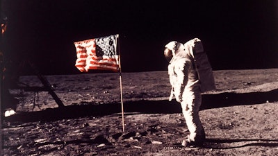 In this image provided by NASA, astronaut Buzz Aldrin poses for a photograph beside the U.S. flag deployed on the moon during the Apollo 11 mission on July 20, 1969. A new poll shows most Americans prefer focusing on potential asteroid impacts over a return to the moon. The survey by The Associated Press and the NORC Center for Public Affairs Research was released Thursday, June 20, one month before the 50th anniversary of Neil Armstrong and Aldrin’s momentous lunar landing.