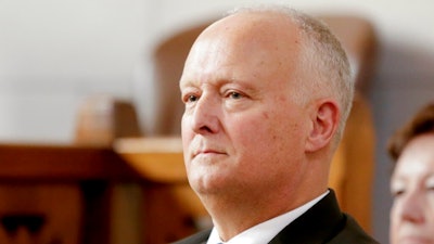 In this Jan. 10, 2019, file photo, Nebraska Attorney General Doug Peterson waits to be sworn in at the State Capitol in Lincoln, Neb. The nation's opioid addiction crisis has prompted 48 states to file lawsuits and another to say it is planning to sue the drugmakers, distributors or pharmaceutical companies. Only one state has not done so. The attorney general in Nebraska has been active in combating opioid addiction but so far has remained on the sidelines while other states and thousands of local governments have taken legal action. Some attorneys for local governments in Nebraska question whether it's the right approach.