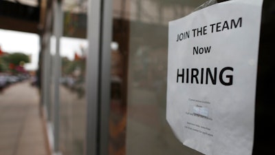 In this July 18, 2018, file photo a 'now hiring' sign hangs in the window of a Chinese restaurant in downtown Fargo, N.D. A U.S. Chamber of Commerce-MetLife survey released last week found that 28% of small businesses plan to increase their staffs in the next year, down slightly from 29% in the first quarter.