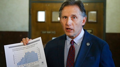 Oklahoma Attorney General Mike Hunter talks with the media during a break the Opioid trial in Norman, Okla., Wednesday, June 26, 2019. Oklahoma is wrapping up its presentation of evidence against Johnson & Johnson in the state's case alleging the consumer products giant and its subsidiaries helped fuel the deadly opioid crisis.