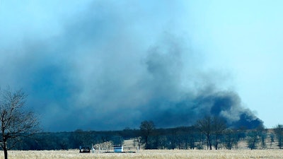 In this Monday, Jan. 22, 2018, file photo, smoke billows from the site of a gas well fire near Quinton, Okla. A federal report says the explosion and fire that killed five workers at the southeastern Oklahoma natural gas well in 2018 was caused by the failure of blowout prevention devices and other factors.