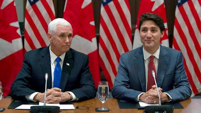 Canadian Prime Minister Justin Trudeau, right, and U.S. Vice President Mike Pence wait for the Canadian Council for the United States–Mexico–Canada Agreement meeting to begin on Parliament Hill in Ottawa, Ontario, Thursday, May 30, 2019.