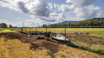 This is the site where a Beechcraft King Air twin-engine plane crashed Friday evening killing multiple people seen on Saturday, June 22, 2019, in Mokuleia, Hawaii. No one aboard survived the skydiving plane crash, which left a small pile of smoky wreckage near the chain link fence surrounding Dillingham Airfield, a one-runway seaside airfield.