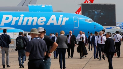 Visitors walk past a Boeing 737-800 BCF Amazon 'Prime Air' cargo plane at the Paris Air Show.