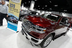In this March 28, 2019 file photo buyers look over a 2019 Ram pickup truck on display at the auto show in Denver.